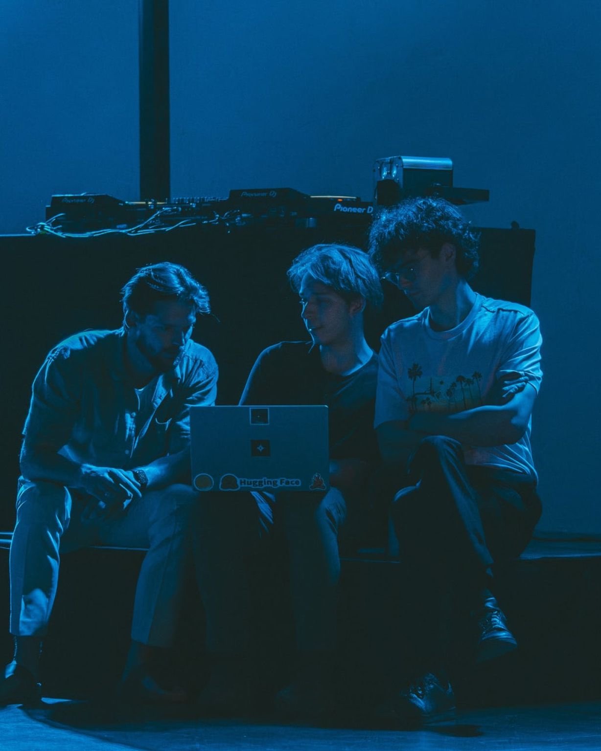 Three builders huddled around a laptop at a North Star event
